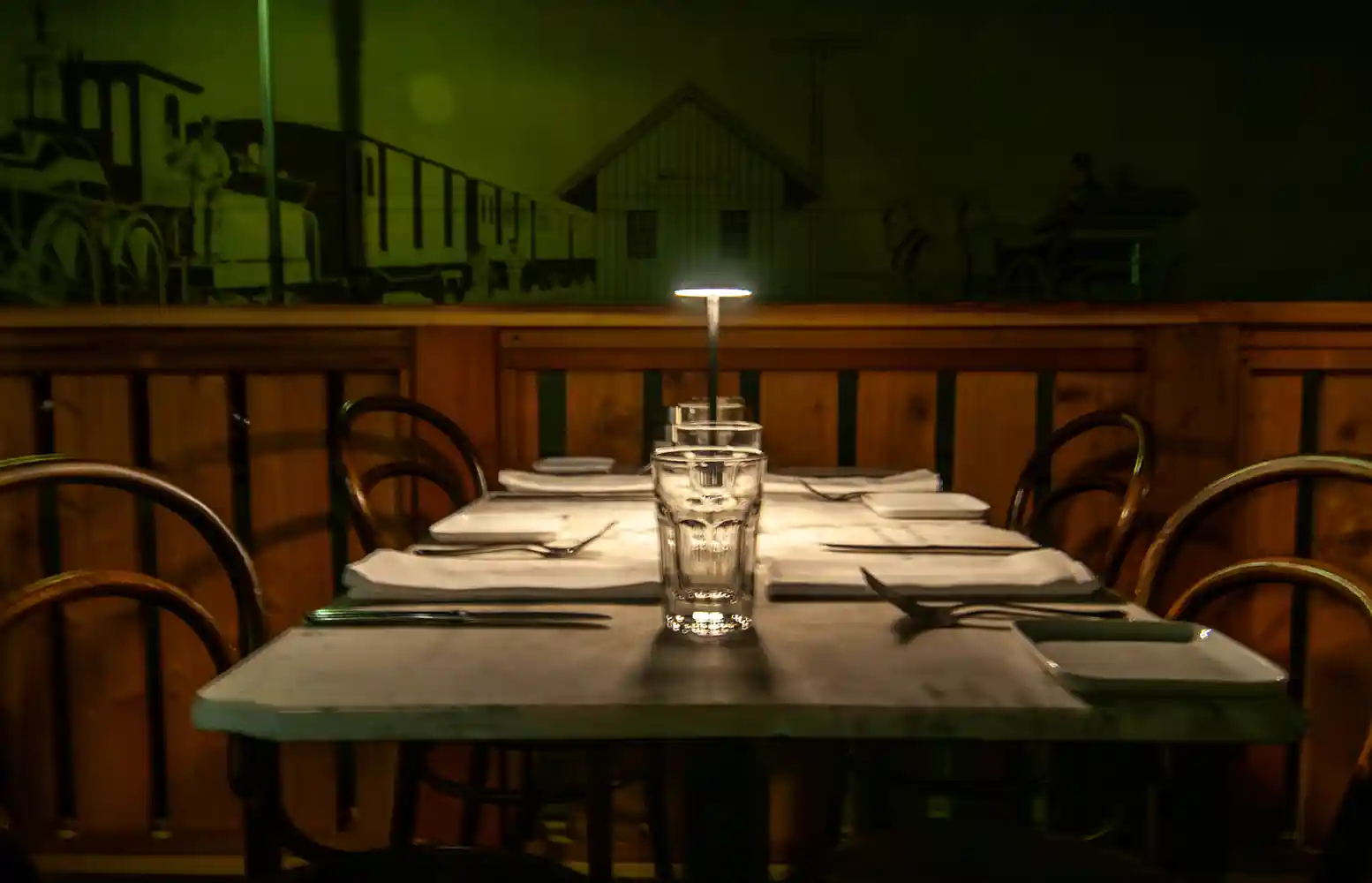 A table on Bistro Elan’s parklet features stylish settings for diners, creating a warm and inviting outdoor space in the heart of Palo Alto.