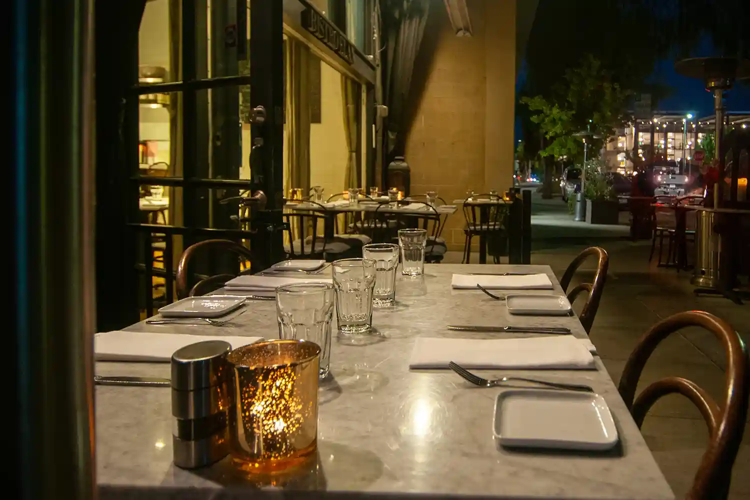 Inviting outdoor seating at Bistro Elan, located near California Avenue in Palo Alto, features comfortable tables and chairs on its patio.